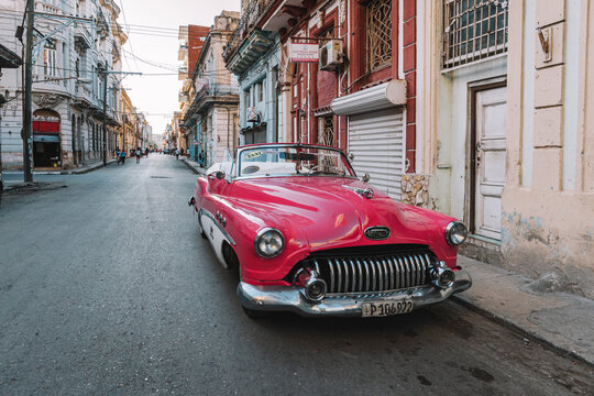 Close-up of old pink Chevrolet parked on Havana street. American classic cars typical of Cuba.