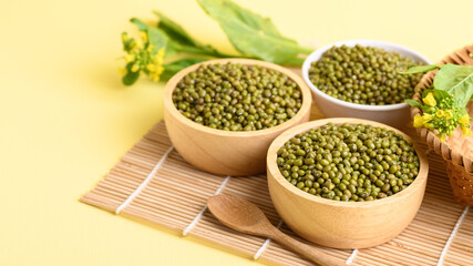 Dry green mung bean seeds in a wooden bowl, Food ingredients in Asian cuisine