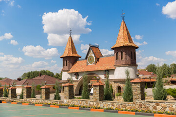 two towers and an old clock on a beautiful castle