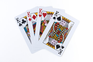 Four kings playing cards for poker casino game isolated on white and gray background.