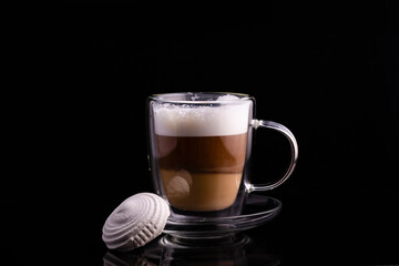 Glass cup with coffee and marshmallows.