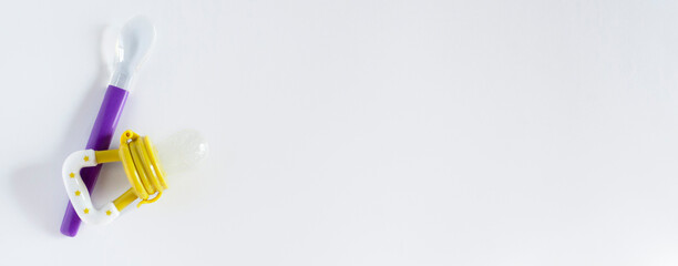 Banner with baby feeding bottle and nibler, Baby food concept, copy space