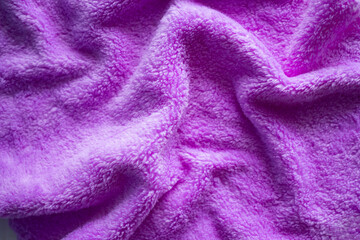 Fototapeta na wymiar Luxuriors purple towel fabric or silk abstract background. of texture and pattern of colorful Purple mess towel fur fabric, top view or flat lay with space for your text.