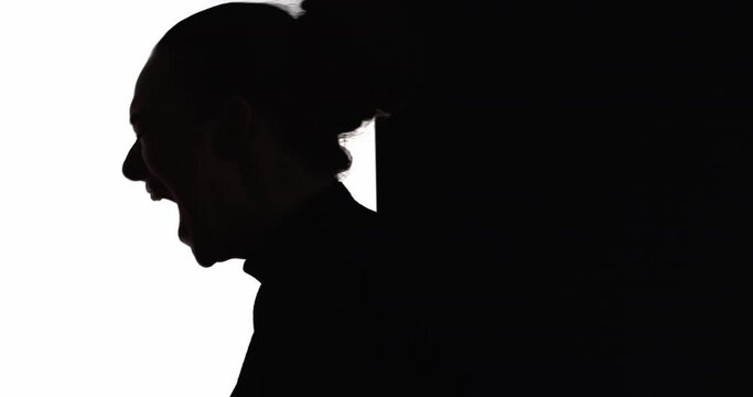 Female silhouette. Mental disorder. Nervous breakdown. Emotional crisis. Dark contrast profile shape of frustrated suffering hurt woman yelling isolated on white black empty space background.