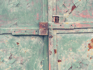 Old green door with locking latch and locking security insert.