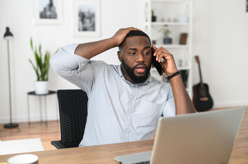 Upset surprised Afro guy talking over the phone, receiving bad news, achieving negative result,...