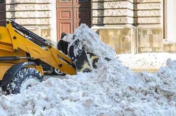  Snow removal tractor clears the road from snow