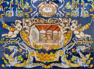 colorful azulejo tile artwork on the side of a pharmacy