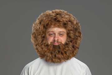 Portrait of young very hairy man isolated over grey background.