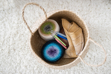 Clews of yarn and spokes in a textile bag. Female hobby.