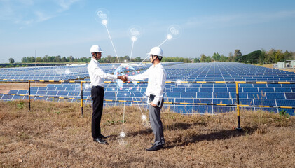Asian businessmen standing check hand with the solar panel in the background. the idea of investors...