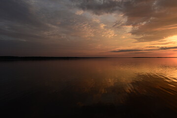Twilight sky reflection in calm water lake