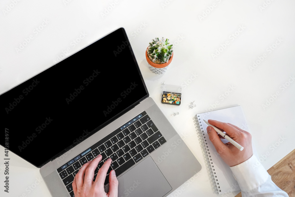 Sticker a male programmer works in front of a laptop screen in a bright office or remotely from home. workpl