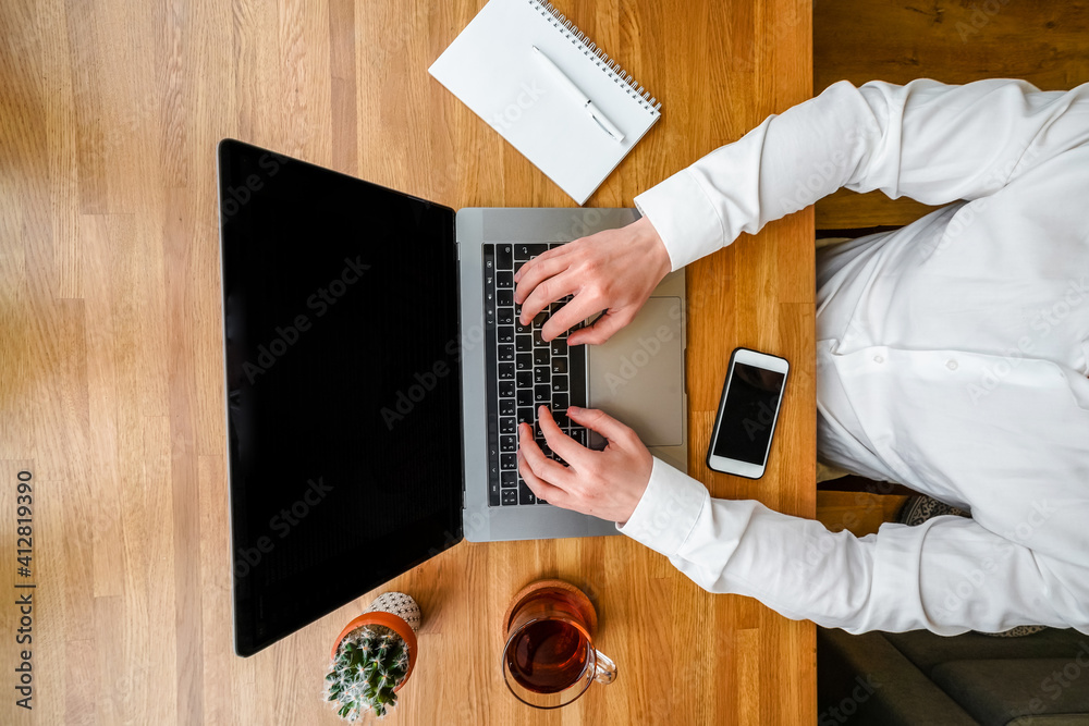 Poster a male programmer works in front of a laptop screen in a bright office or remotely from home. workpl