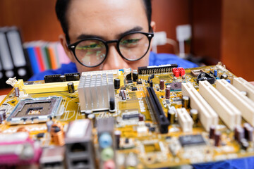 Technicial professinoal looking part to repair computer motherboard and processor.