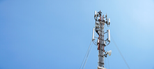 workers are working at 5g antenna tower for maintaining.serves cellular antenna, technician worker repair telecommunication tower on sunlight at background.	
