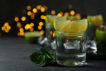 Concept of party drink with shots of vodka and blurred lights