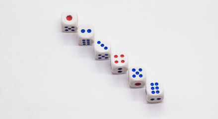 Heap of white cubic tree six dices with blue and red spikes (dots) on a white background. Game, gambling, chance and risk concept