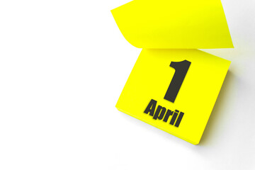 April 1st . Day 1 of month, Calendar date. Close-Up Blank Yellow paper reminder sticky note on White Background. Spring month, day of the year concept.