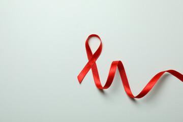 Obraz na płótnie Canvas Red awareness ribbon on white background, space for text