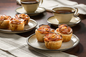 Apple rose puffs on the table with cups of tea