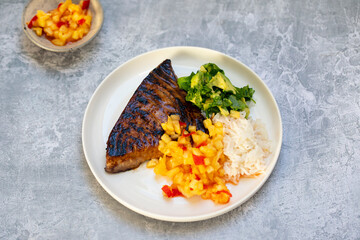 Seared tuna steak with pineapple salsa, rice and avocado