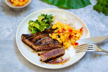 Seared tuna steak with pineapple salsa, rice and avocado