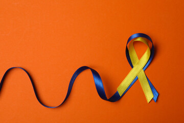 Down Syndrome awareness ribbons on orange background