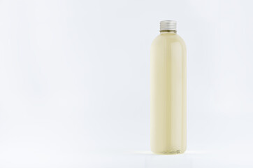 Transparent plastic tall thin bottle with pale fresh drink or cosmetic essential oil, silver cap mockup on white background.