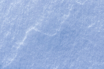 Obraz premium blue texture of an ice surface covered with snow ,cold clear cryslallized wall background ,winter frozen surface close up , abstract macro wallpaper