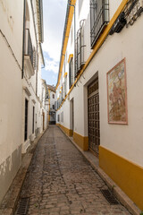 narrow and deserted city street in the old city center of Cordoba