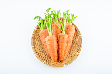 Fresh carrots in a pot on white background