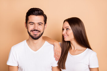 Photo of cute adorable husband wife wear white t-shirts smiling arm shoulder isolated beige color background