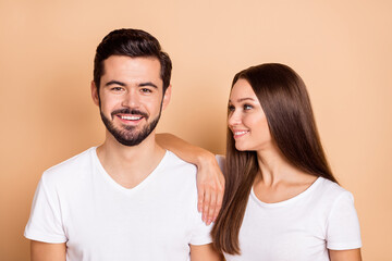 Fototapeta premium Photo of cute adorable husband wife wear white t-shirts smiling arm shoulder isolated beige color background