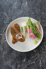 beetroot snack with bread and chips in a white plate vertically
