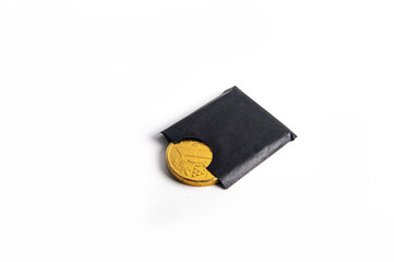 Yellow metal coin Ukrainian currency, in a brown plastic case on a white background