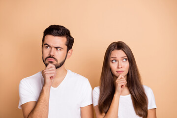 Photo of sad pensive husband wife wear white t-shirts arm chin looking empty space isolated beige color background