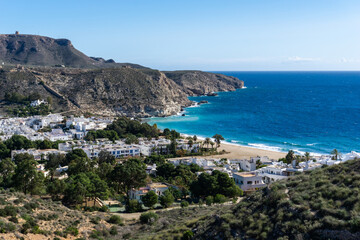 view of the idyllic whitewashed fishing village of Agua Amarga on the coast of Andalusia