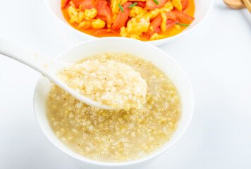 Chinese food set meal quinoa millet porridge with tomato scrambled eggs