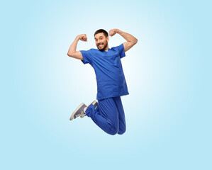 healthcare, profession and medicine concept - happy smiling doctor or male nurse in uniform jumping...