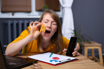 An English teacher teaches lessons online with. laptop and smartphone. Study of the sound of letters.