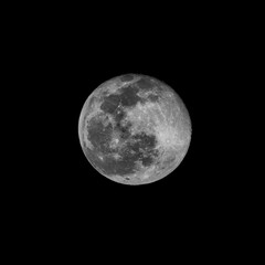 crisp structured and bright full moon in a black nightv sky