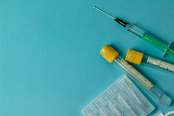 Fototapeta na wymiar Medical vials for injection, syringe for injection, mask gloves on a blue background. Admission vaccination, flu shot