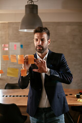 Businessman in conference room. Young businessman in suit making a business plan..