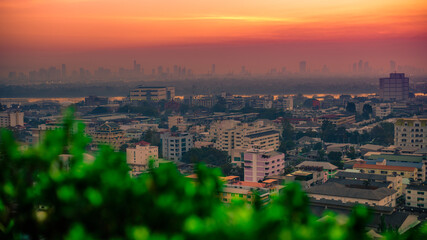 The high angle background of the city view with the secret light of the evening, blurring of night lights, showing the distribution of condominiums, dense homes in the capital community