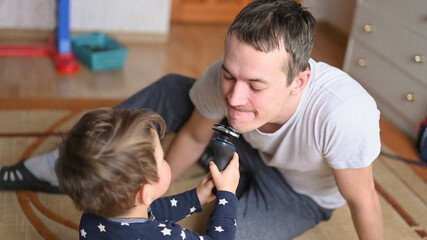 Child shaves father with cordless razor
