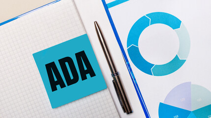 There is a pen between the blue sticky note with the text ADA and the blue chart. Business concept....