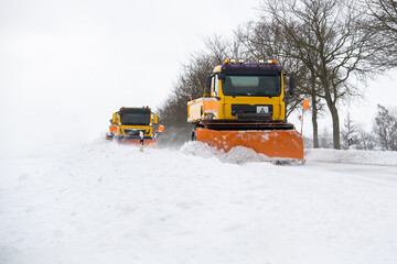 Räumfahrzeug auf schneebedeckter Straße im Winterdienst
