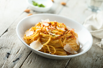 Spaghetti with red pesto sauce and cheese