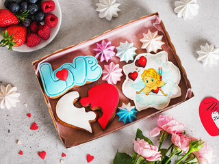 Valentine's day romantic breakfast. Gingerbread Heart with icing. Surprise for your beloved. A gift for Valentine's Day. Dessert for the holiday. Family date. Image of Cupid. Fresh berries, flowers.